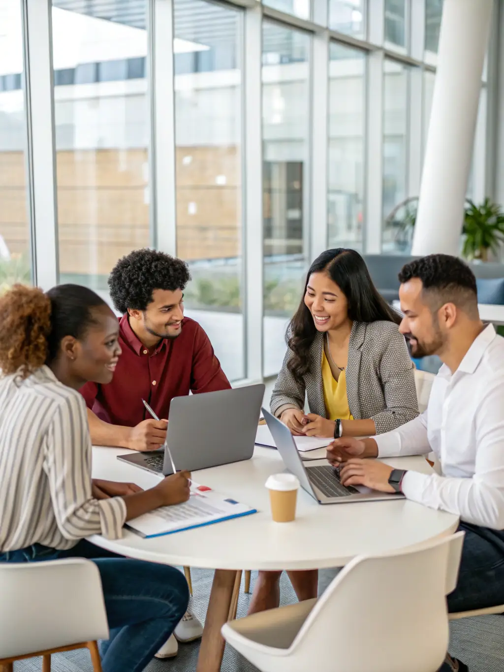 A diverse team of UK business professionals collaborating on a strategic plan in a bright, modern office.